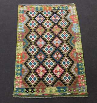 A black, green and blue ground Chobi Kilim rug with all over geometric design 203cm x 129cm 