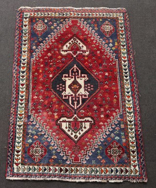 A red and blue ground Afghan rug with central medallion 182cm x 119cm 