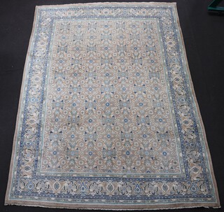A mushroom and blue Persian carpet with all over geometric design 398cm x 290cm 