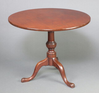A 19th Century circular mahogany snap top tea table raised on turned column and tripod base 70cm h x 86cm diam. 