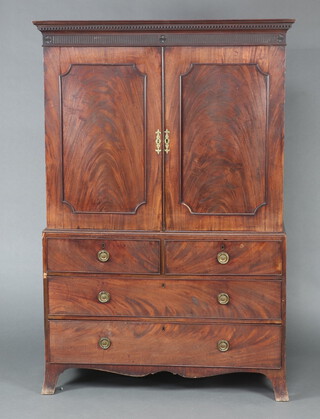 A Georgian mahogany linen press, the upper section with moulded dentil cornice, fitted 5 trays enclosed by a pair of panelled doors, the base fitted 2 short and 2 long drawers, raised on bracket feet 189cm h x 126cm w x 62cm d 