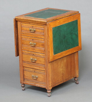 An Edwardian oak pedestal office drop flap table, the pedestal fitted 4 short drawer, raised on bun feet with casters 74cm h x 38cm w x 53cm d (when open 114cm w) 