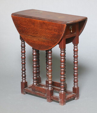 A 1920's 17th Century style oak drop flap gateleg tea table, fitted a frieze drawer, raised on bobbin turned supports 66cm h x 60cm x 24cm (when closed) x 72cm (when open)