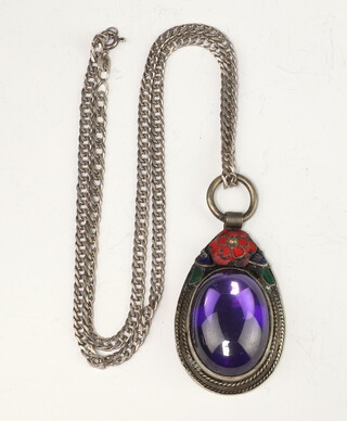 A Chinese white metal amethyst and enamel pear shaped pendant on a white metal chain 