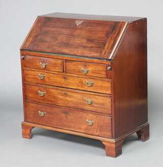 A Georgian mahogany bureau, the fall front revealing a well fitted interior with drawers and pigeon holes above 2 short and 3 long graduated drawers with replacement brass drop handles, raised on bracket feet 100cm h x 91cm w x 50cm d 