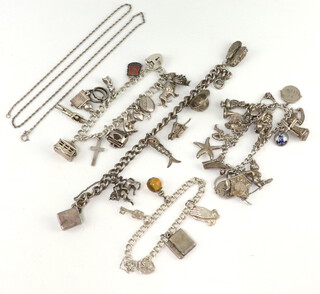 Four silver charm bracelets and a silver chain, 139 grams 