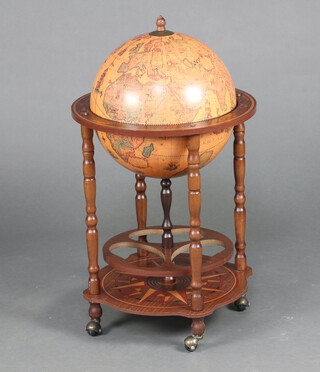 A drinks cabinet in the form of a terrestrial globe, raised on turned supports 82cm h x 50cm diam. 