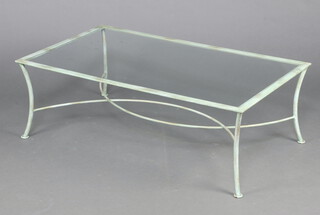 A rectangular green painted metal coffee table with plate glass top raised on outswept supports with X framed stretcher 41cm h x 120cm w x 70cm d 