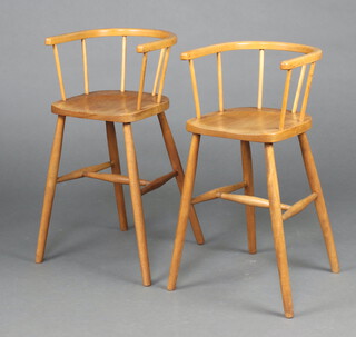 A pair of children's elm and beech tub back chairs, raised on turned supports 71cm h 
