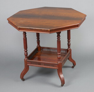 A Victorian octagonal 2 tier mahogany occasional table on turned and reeded supports 73cm h x 84cm w x 83cm d (split to top, contact marks in places)