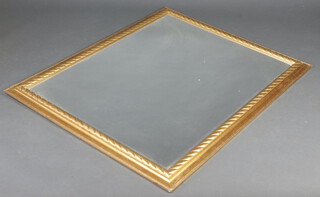 A rectangular bevelled plate wall mirror contained in a decorative gilt frame 138cm x 107cm - PLEASE NOTE THIS MIRROR WAS CATALOGUED TWICE, (so the sale has been cancelled, its official lot number was 429 and sold for 60.00