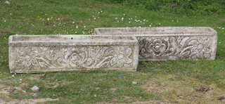 A pair of well weathered rectangular concrete garden trough shaped planters with cast flower head decoration 25cm h x 100cm w x 25cm d 