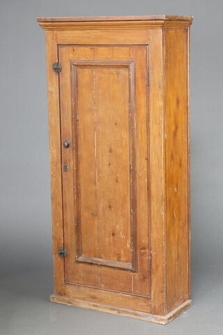 A Victorian pine cabinet with moulded cornice, fitted shelves enclosed by a panelled door 163cm h x 79cm w x 34cm d 