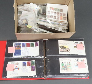 An album of GB Elizabeth II first day covers and a quantity of loose mint and used stamps, contained in a cardboard box