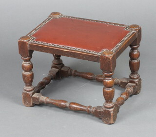 A rectangular oak stool with brown rexine seat, raised on turned and block supports 30cm h x 40cm w x 30cm d 