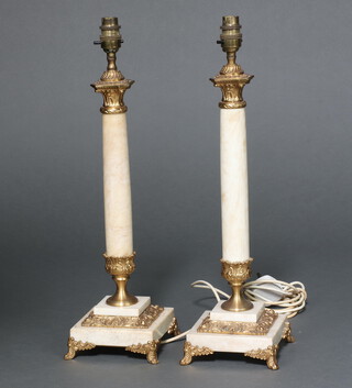 A pair of onyx finished and gilt metal candlesticks on square bases 43cm 