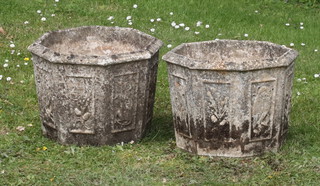 A pair of octagonal well weathered concrete garden urns 27cm x 34cm 