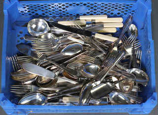 A quantity of silver plated flatware contained in a blue plastic tray 