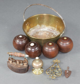 A brass preserving pan with polished steel handle together with 2 RG Lawrie lignum vitae bowling woods, a table bell and 2 flat irons 