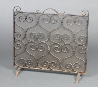 A wrought iron and mesh spark guard 54cm h x 60cm w x 22cm d 