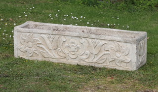 A rectangular weathered concrete garden urn with floral decoration 24cm h x 27cm w x 24cm d 