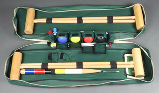 A Jacques croquet set contained in a fabric carrying case, comprising 4 mallets, 6 hoops, 4 balls, peg and instructions 