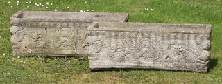 A pair of rectangular well weathered concrete garden trough shaped planters with cast mask and floral decoration 25cm h x 71cm w x 23cm d 