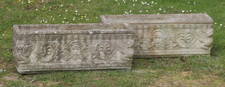 A pair well weathered concrete garden trough shaped planters with cast mask decoration 25cm h x 71cm w x 24cm d 