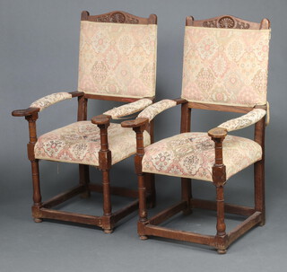 A pair of carved oak show frame high back open arm chairs with upholstered seats and backs on turned supports 115cm h x 61cm w x 63cm d (1 has a repair to arm)  