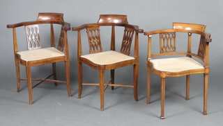 A pair of Edwardian inlaid mahogany corner chairs with upholstered seats raised on square supports 76cm h x 65cm w x 56cm w and 1 other similar chair (3) 