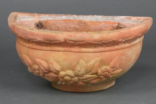 A terracotta crescent shaped wall planter 25cm h x 51cm w x 22cm d 