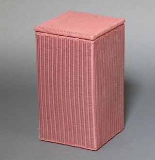 A pink painted Lloyd Loom linen basket with hinged lid 54cm h x 30cm w x 30cm d 