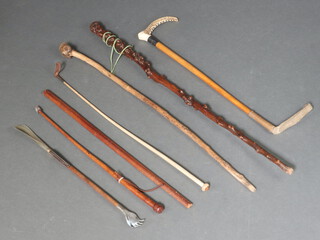 A hunting crop with stag horn grip and silver mount together with a collection of walking sticks and whips 