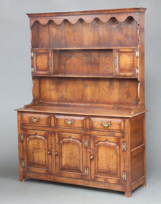 An 18th Century style oak dresser, the raised back fitted 2 shelves flanked by cupboard, the base fitted 3 drawers above cupboards 184cm h x 137cm w x 46cm d 