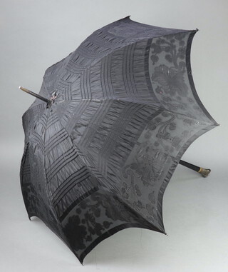 A Victorian parasol with ebony handle (a/f, fabric torn in places)