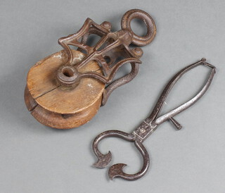 A 19th Century wooden and iron pulley 28cm together with a pair of polished steel sugar cutters 26cm 