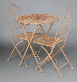 A circular pierced metal Bistro style set comprising folding table 72cm h x 59cm diam. and 2 folding chairs 