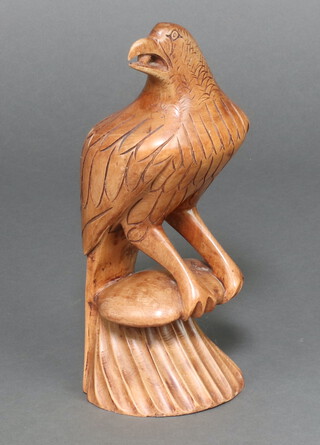 A carved wooden figure of a seated bird 40cm x 15cm 