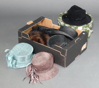 A Harrods hat box and a collection of ladies hats 