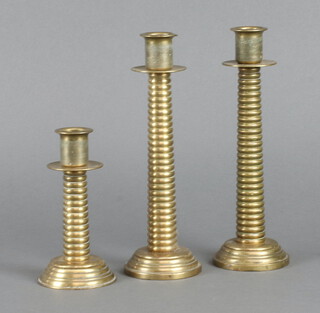 A pair of turned brass "trench art" style candlesticks 22cm and 1 other 13cm 