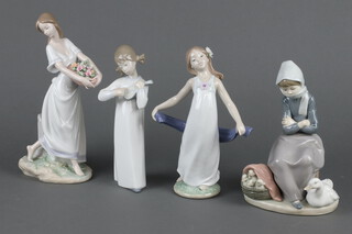 A Lladro figure of a girl carrying a basket of flowers 24cm and 3 other figurines 21cm 