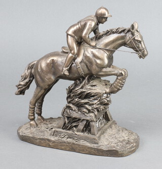 A bronzed figure of a show jumper 27cm x 20cm x 9cm 