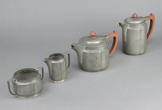 An Art Nouveau pewter hammered pattern 4 piece tea and coffee set with wooden handles 