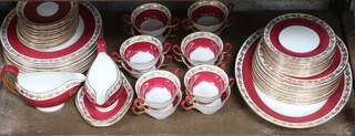 A Wedgwood burgundy and gilt vinous decorated dinner service no. W3994 comprising 12 two handled cups, 12 saucers,12 small plates, 12 side plates, 11 dinner plates, 2 sauce boats and stands, 2 oval serving plates  