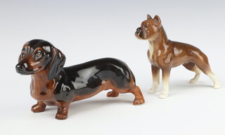 An Alton China figure of a standing Dachshund 20cm (base of ear restored) and a Sylvac figure of a Boxer dog 13cm 