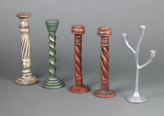 A pair of Indian turned and carved hardwood candlesticks 37cm together with 2 other turned candlesticks 40cm and 38cm and a metal 3 light candelabrum 41cm 