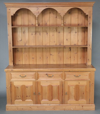 A large pine dresser, the raised back with moulded cornice and 2 shelves, the base fitted 3 drawers above triple cupboards 203cm h x 167cm w x 44cm d 