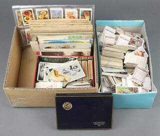 A quantity of silk cigarette cards in a Players cigarette tin, various lose cigarette cards and 10 cigarette card albums and contents together with a collection of loose cigarette cards contained in 2 small boxes 