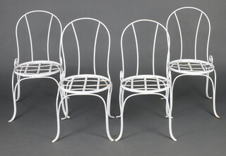 A set of 4 white painted wrought metal garden chairs with circular seats on cabriole supports 79cm h 