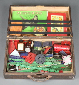 A collection of red and green Meccano contained in a pine box with hinged lid 